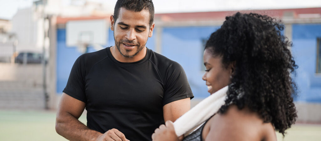 GLP-1 medical weight loss patient talking to fitness and nutrition coach about her progress, the importance of having a coach