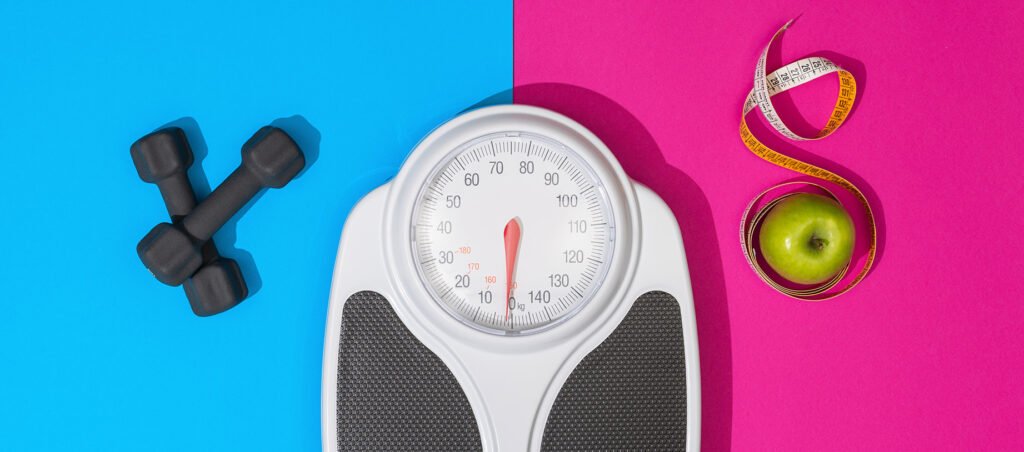 Weight loss image with scale, dumbbells, and measuring tape showing what to do if you're not losing weight with GLP-1 medications like Ozempic, Mounjaro, or Wegovy