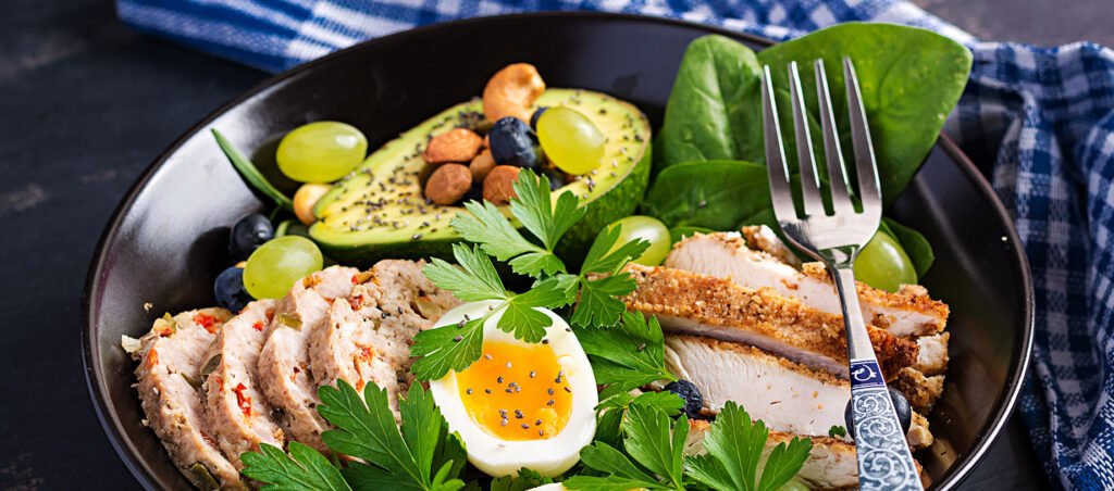 High protein salad with boiled egg, chicken, and nuts, example of high protein food for GLP-1 diet