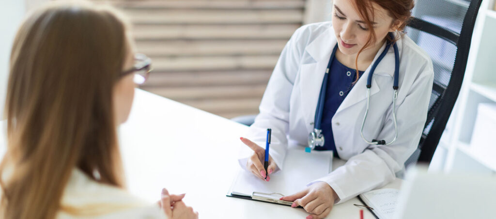 Nurse Practitioner speaks with female patient about nutrition and lifestyle modifications during consult to prescribe a GLP-1 medication for weight loss