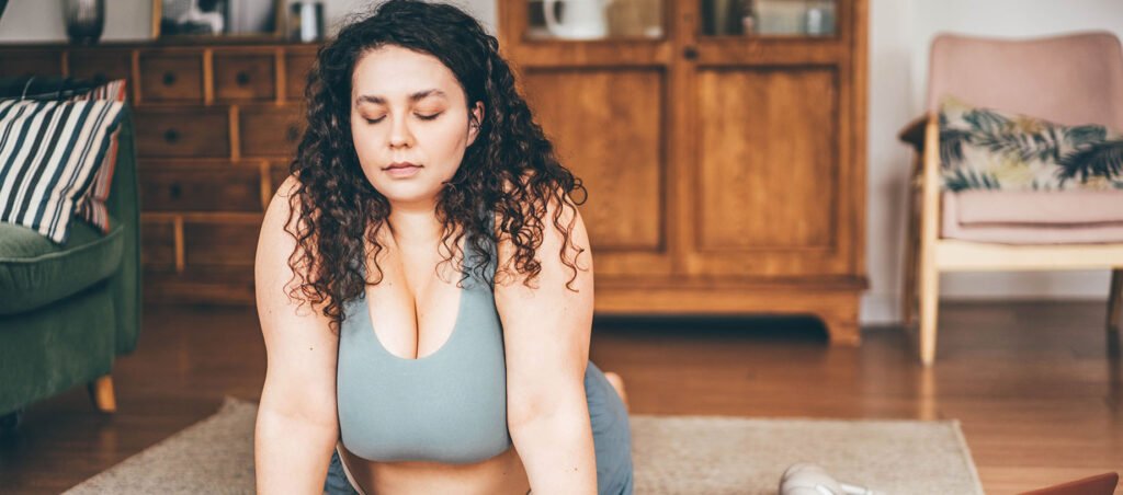 Lady doing yoga to help with mindset & mental health along her GLP-1 medical weight loss journey with Ozempic