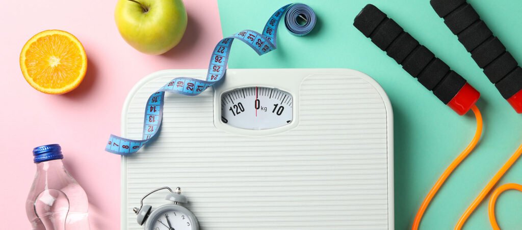 Image with scale and exercise tools highlighting the importance of nutrition, coaching, and mental health along a GLP-1 weight loss journey with prescriptions like Ozempic