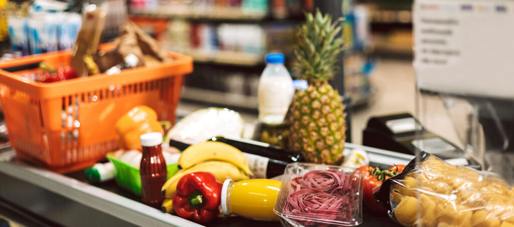 Grocery store conveyor belt full of nutritious food as GLP-1 patient checks out with her Ozempic meal plan