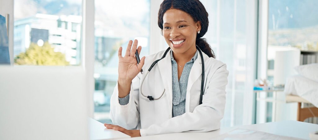 Obesity medicine doctor waves to GLP-1 patient through webcam as she begins telehealth visit for weight loss and diabetes management with Ozempic