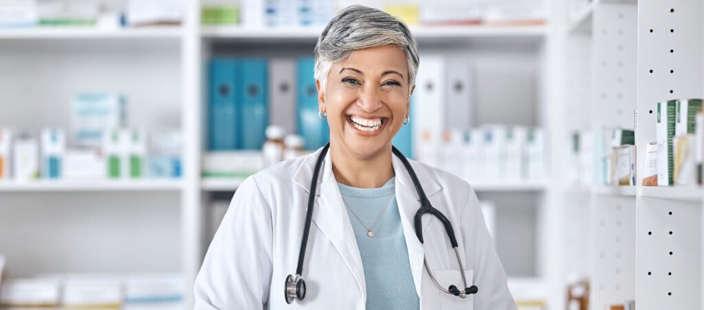 Female doctor smiles at camera in her medical weight loss clinic before seeing patients