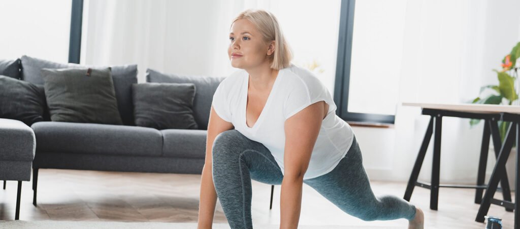 Lady taking GLP-1 medication for weight loss and diabetes management exercises with yoga equipment in a home gym setting