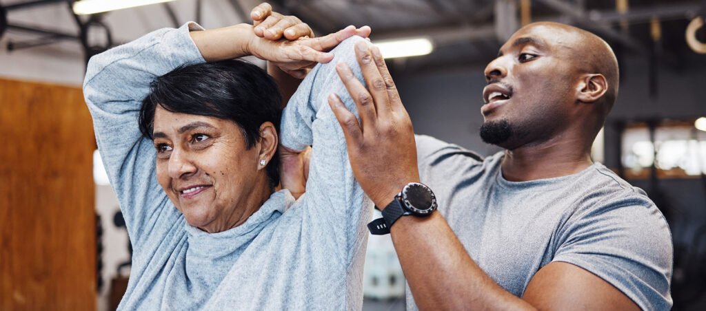 Personal trainer works with a client in a gym setting who is taking a GLP-1 prescription for medical weight loss overseen by an obesity medicine specialist