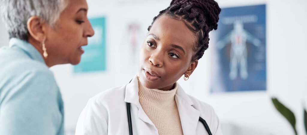 Obesity medicine specialist speaks with patient in a clinic setting about her GLP-1 prescription for medical weight loss