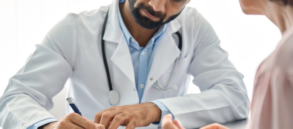 Medical weight loss doctor prescribes GLP-1 medication to female patient in his office after assessing her needs for weight loss