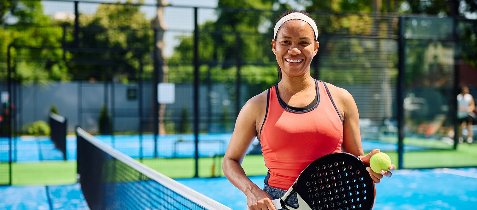 Young lady playing paddle tennis at a country club to support weight management and healthy living.