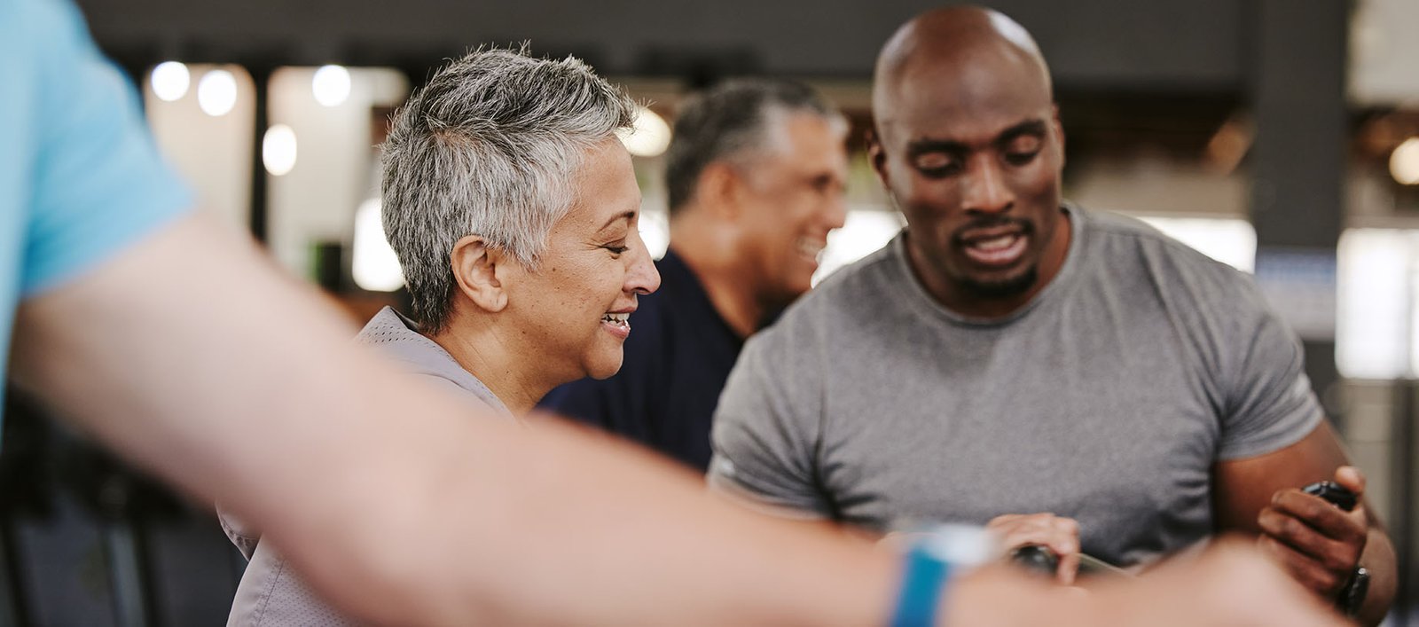 Personal trainer working with a member at a luxury country club or wellness club to help achieve wellness, weight management, and longevity goals.