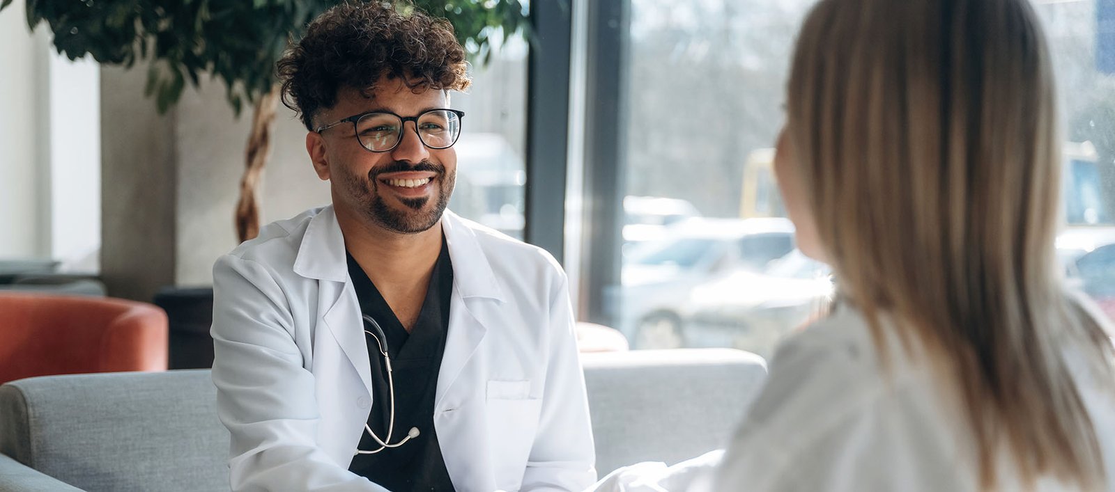 Healthcare provider consulting with patient in modern clinic office about personalized Alterra Health lifestyle care plan.